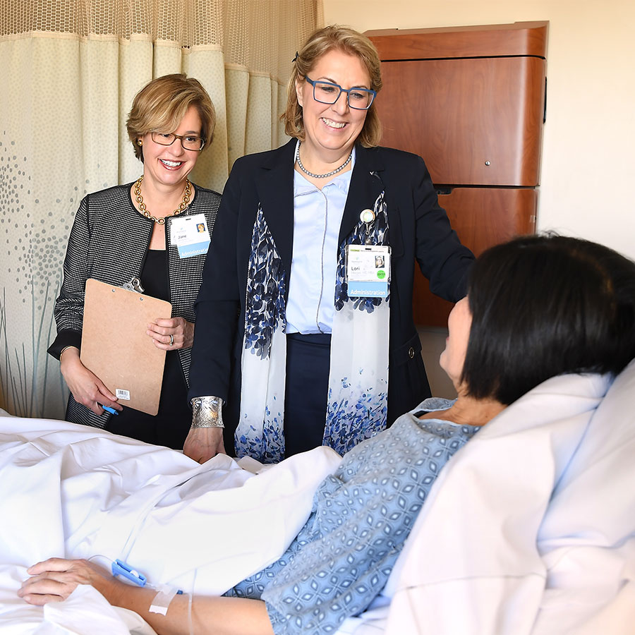 Two Huntington Hospital Team members visit patient
