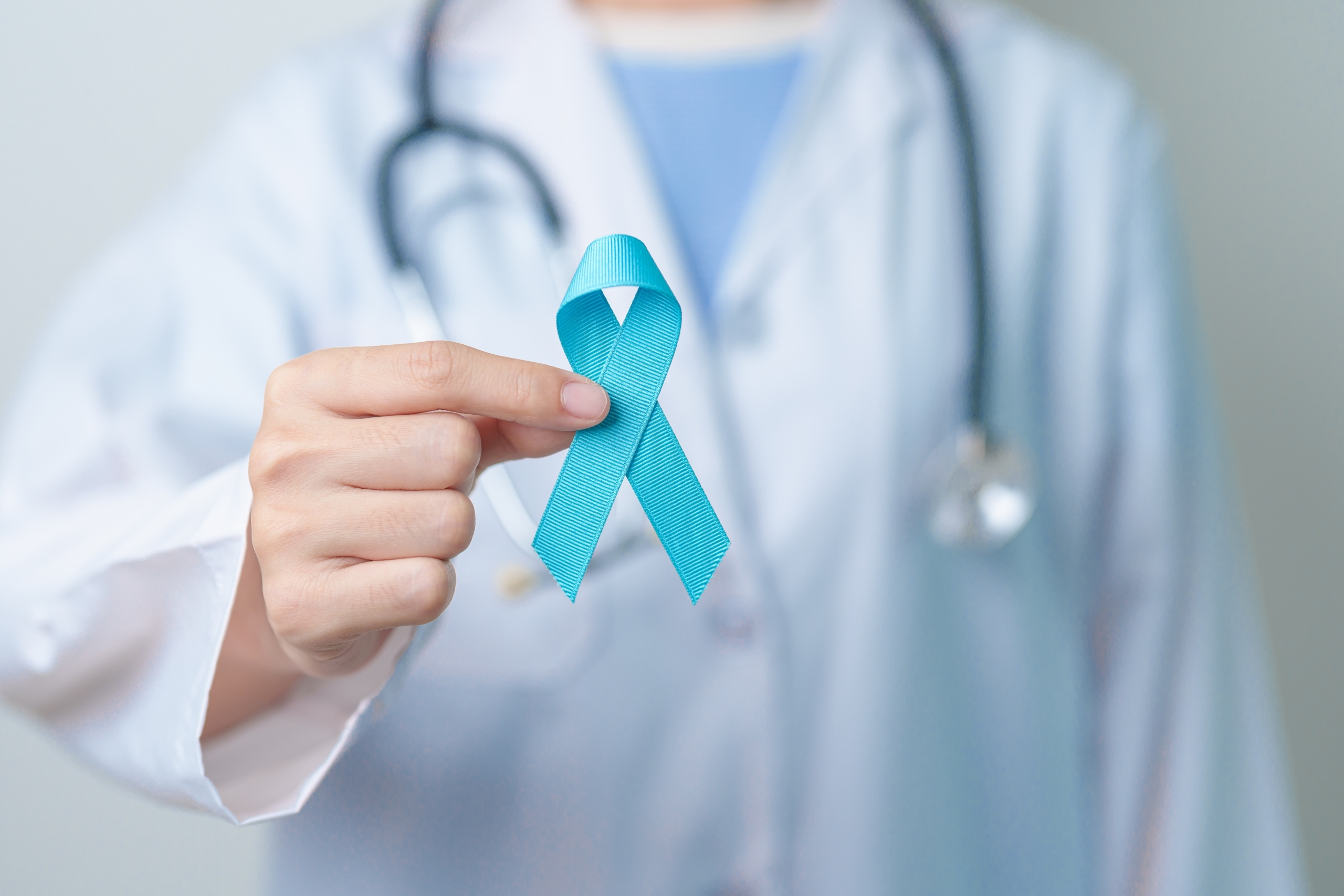 doctor holding pale Blue ribbon