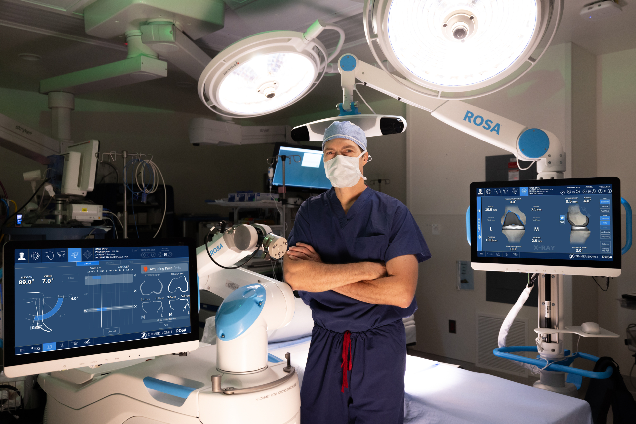 Todd Dietrick, MD, standing in front of robotic surgical equipment: ROSA ® Knee System: Robotic Knee Replacement