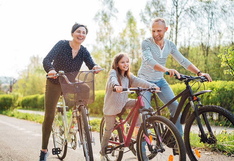 A couple and their daughter, riding bikes