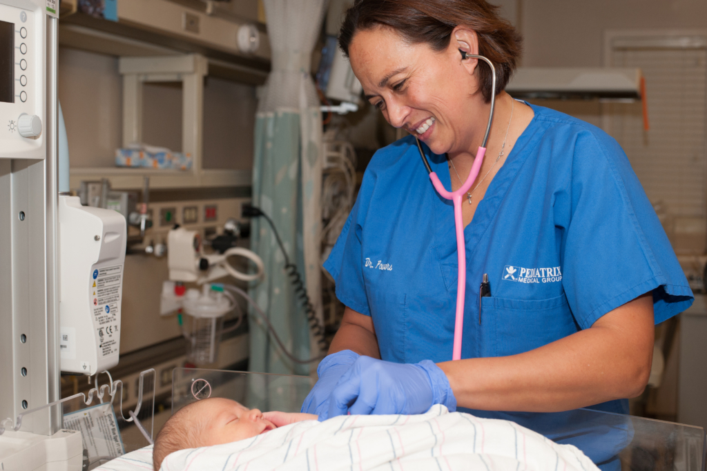 Doctor checking on a baby in the NICU