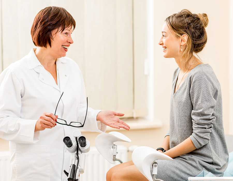 Female gynecologist talking to female patient