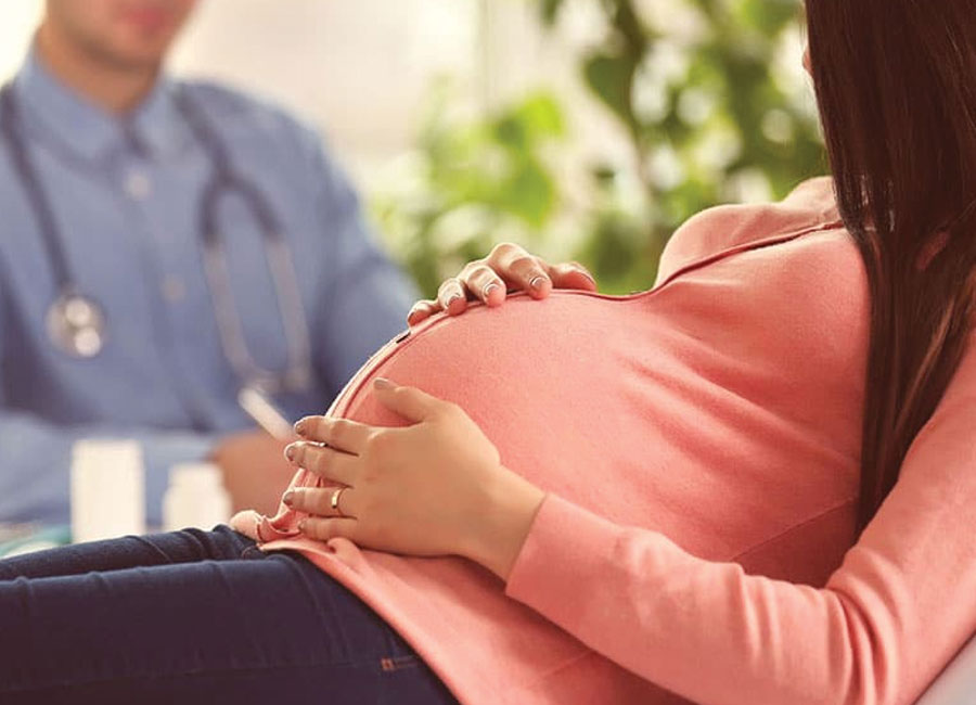 Pregnant woman with hands on belly