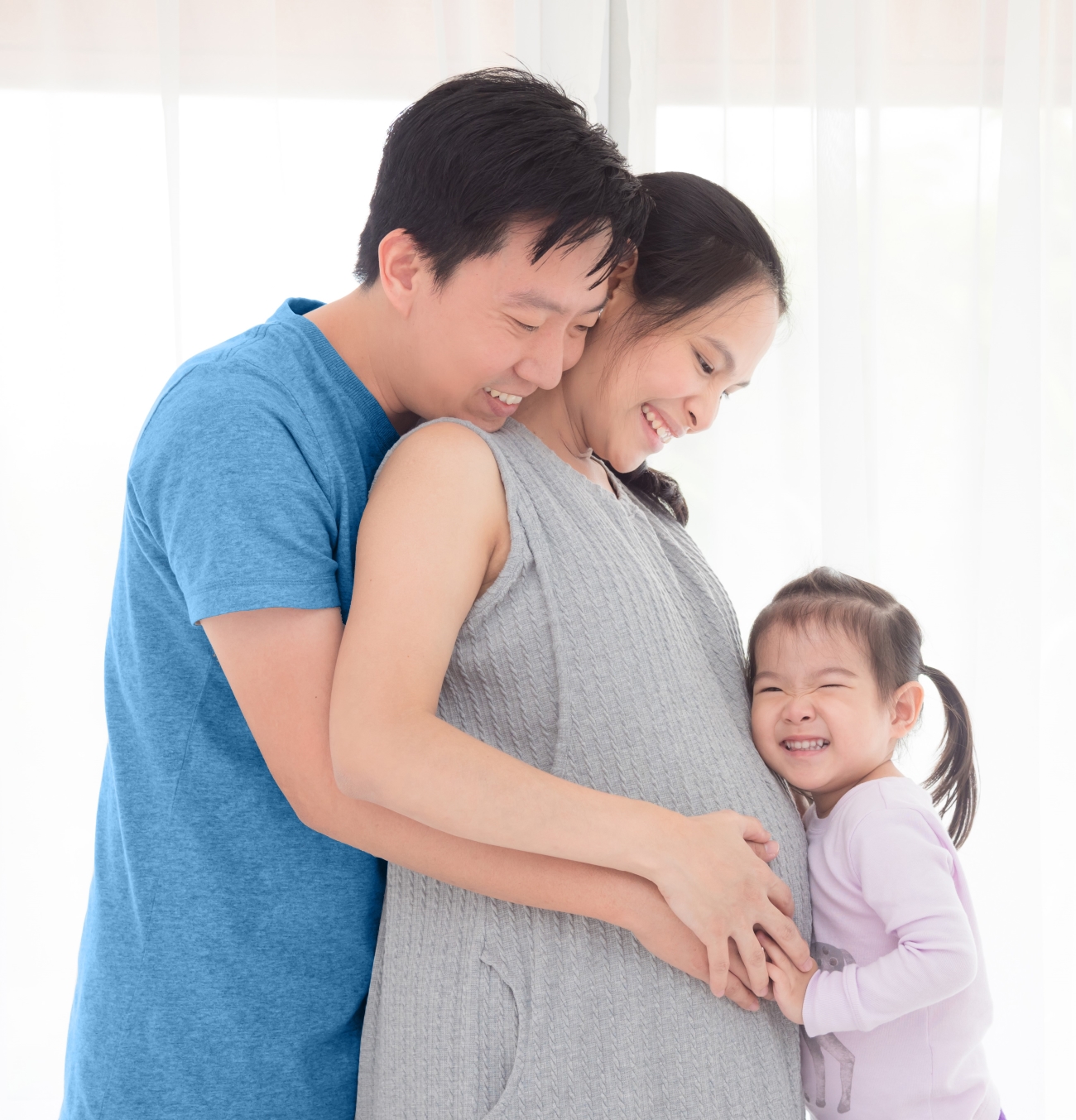 Family celebrating mother's pregnancy