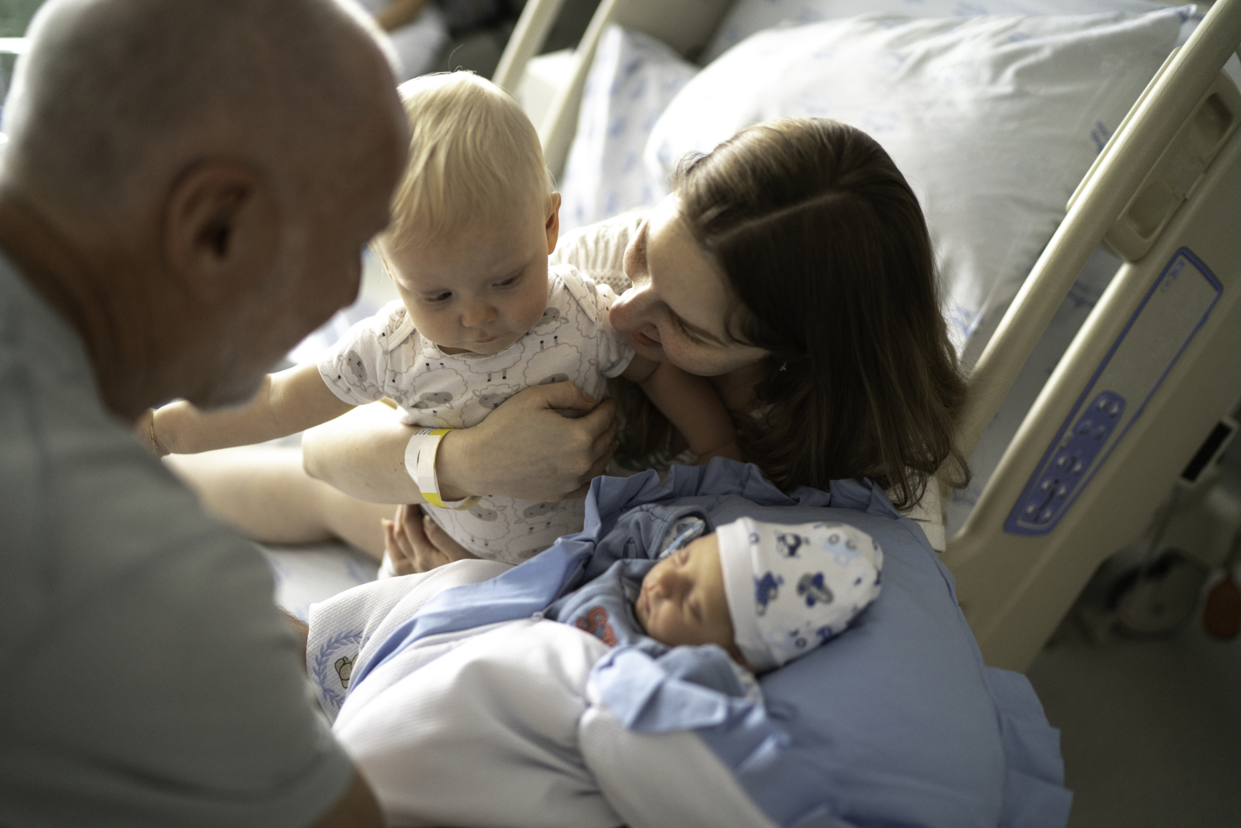 mom introduces her son to his new baby brother in hospital